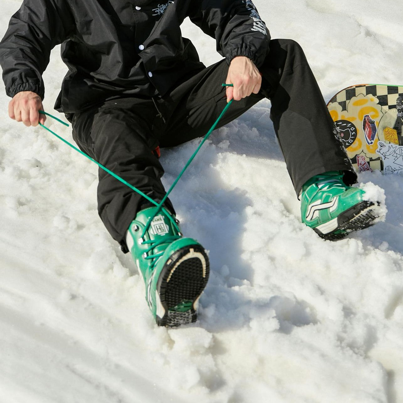 Person tying snowboard boots
