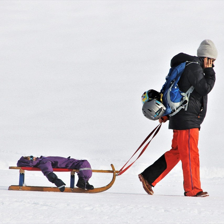 Kiddo being pulled on a sled while napping